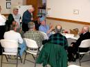 George Schmidt, WA4GBD (seated, in the blue cap), is explaining the equipment and methods used in foxhunting.