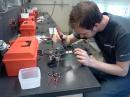 David Conradi, KD0NUK, one of our electrical engineering majors, working on four transmitter boards at the same time.