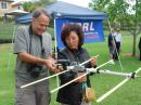 ARDF equipment need not be expensive. Yagis made from measuring tapes and PVC pipe are very popular for direction finding on 2 meters with an hand-held transceiver. Here, Dan Slater, AG6HF (left), is testing an antenna he built at an introductory session in California. (Joe Moell, KØOV, photo)