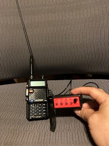 Figure 3. A simple fox can be created by using a Ham Gadgets Ultra-Pico Keyer as the Morse code beacon. The audio line is plugged into the mic input of the handheld radio.